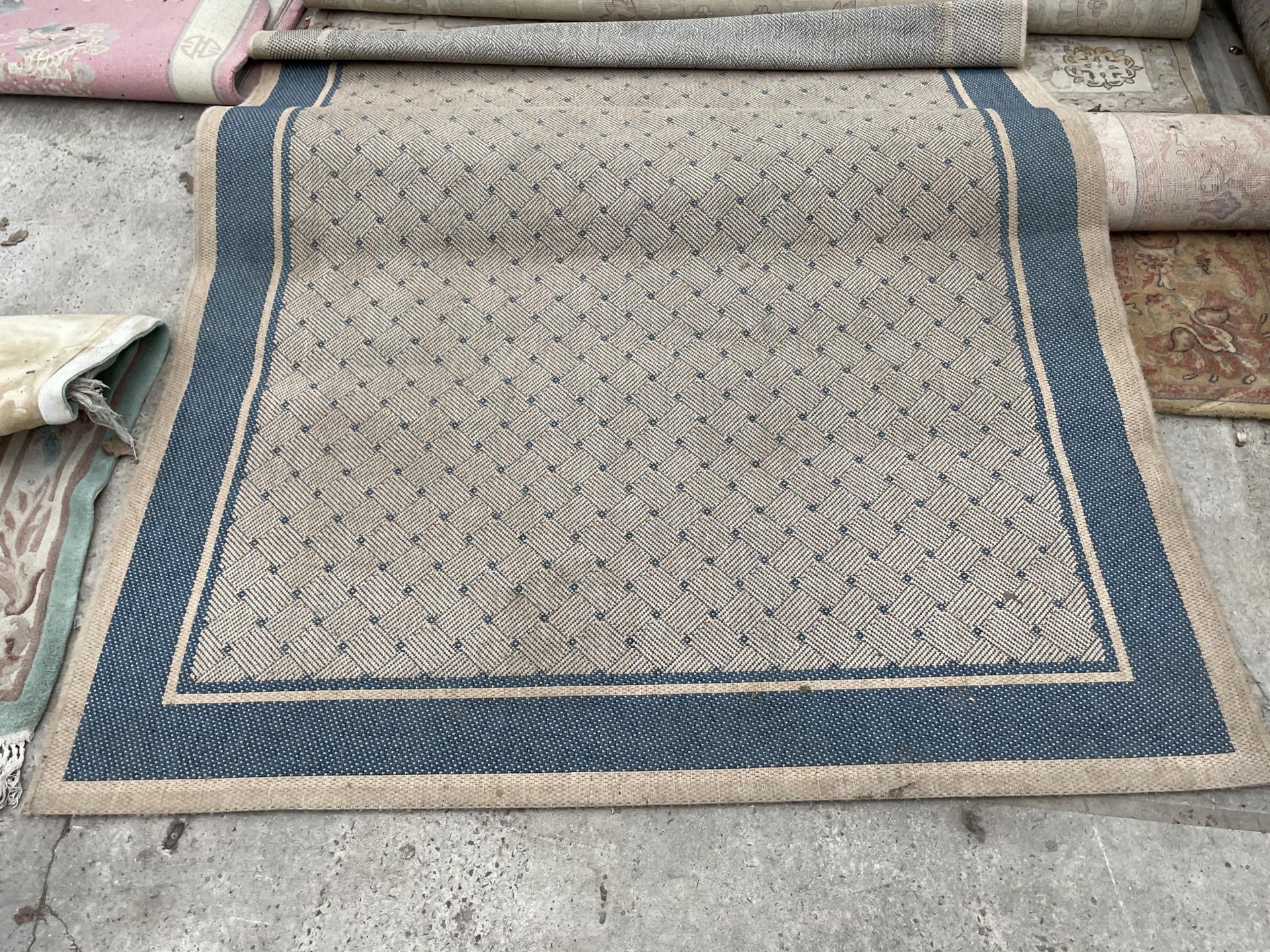 A MODERN BLUE AND CREAM RUG