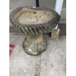 A DECORATIVE CONCRETE BIRD BATH WITH PEDESTAL BASE