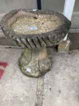 A DECORATIVE CONCRETE BIRD BATH WITH PEDESTAL BASE