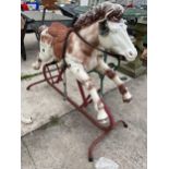 A VINTAGE PLASTIC CHILDS ROCKING HORSE WITH METAL FRAME AND BASE