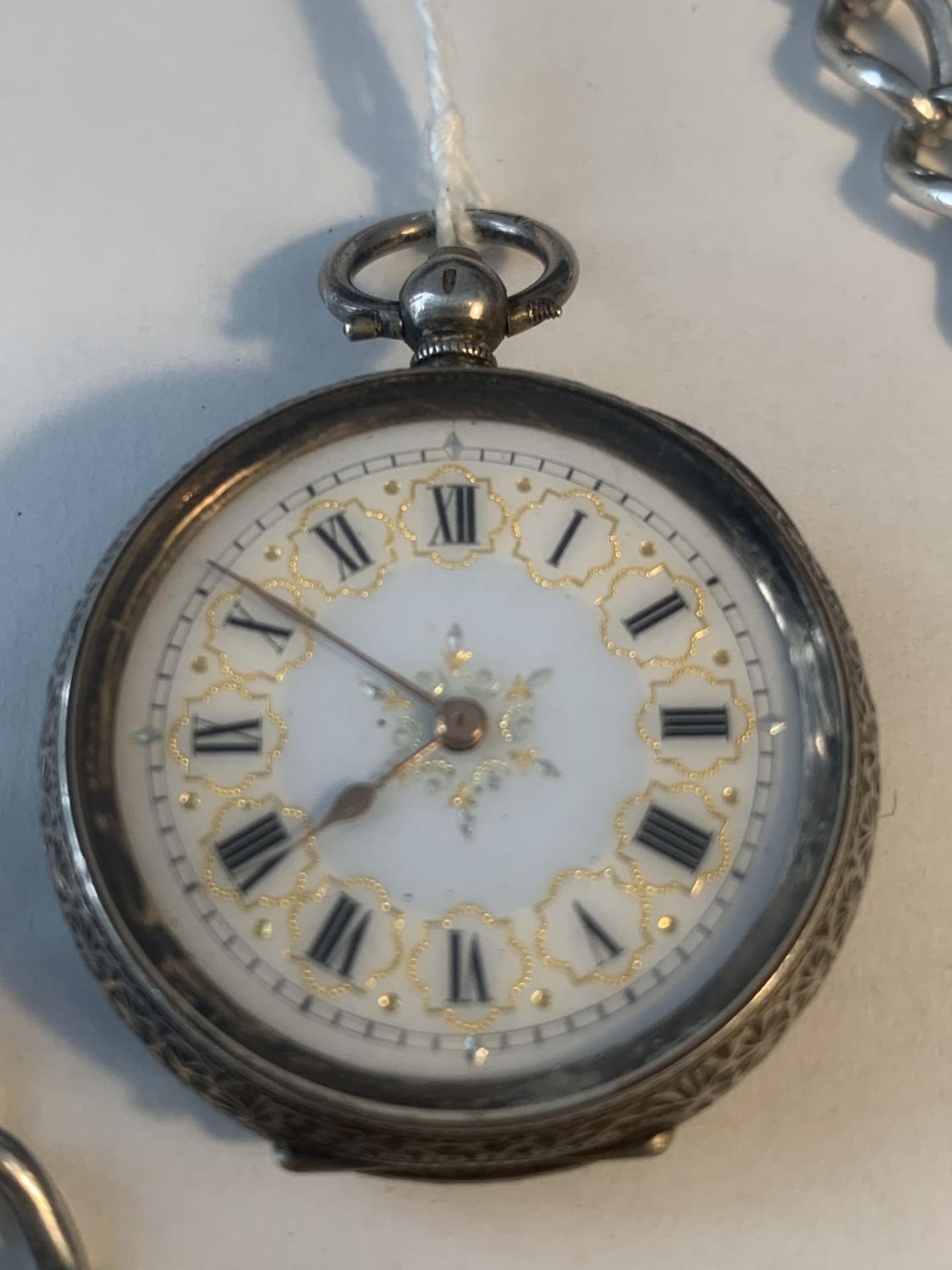 A MARKED 935 SILVER LADIES POCKET WATCH WITH DECORATIVE FACE AND CASE WITH A MARKED T BAR CHAIN - Image 2 of 6