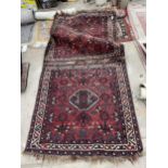 A SMALL VINTAGE RED PATTERNED FRINGED RUG