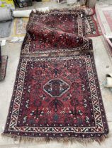 A SMALL VINTAGE RED PATTERNED FRINGED RUG