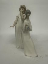 A NAO FIGURE OF A GIRL YAWNING TOGETHER WITH A MIQUEL REQUENA S.A. FIGURE OF A GIRL HOLDING A CANDLE