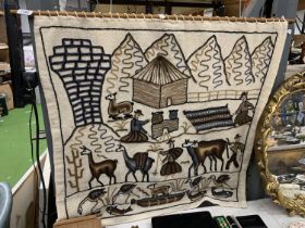 A NAIVE WOOLWORK WALL HANGING WITH ANIMALS, FIGURES AND MOUNTAINS, APPROX 84CM X 80CM