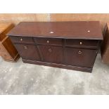 A STAG MINSTREL SIDEBOARD ENCLOSING THREE DRAWERS AND THREE CUPBOARDS, 54" WIDE