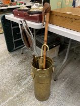 A VINTAGE BRASS STICK/UMBRELLA STAND WITH LION HANDLES, A SHOOTING STICK AND ELEPHANT HEADED WALKING