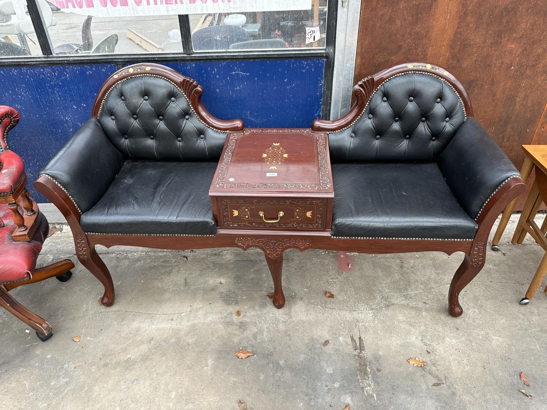 A BRASS INLAID INDIAN HARDWOOD AND BUTTONED LEATHER SCROLL END CONVERSATION DOUBLE SEAT WITH