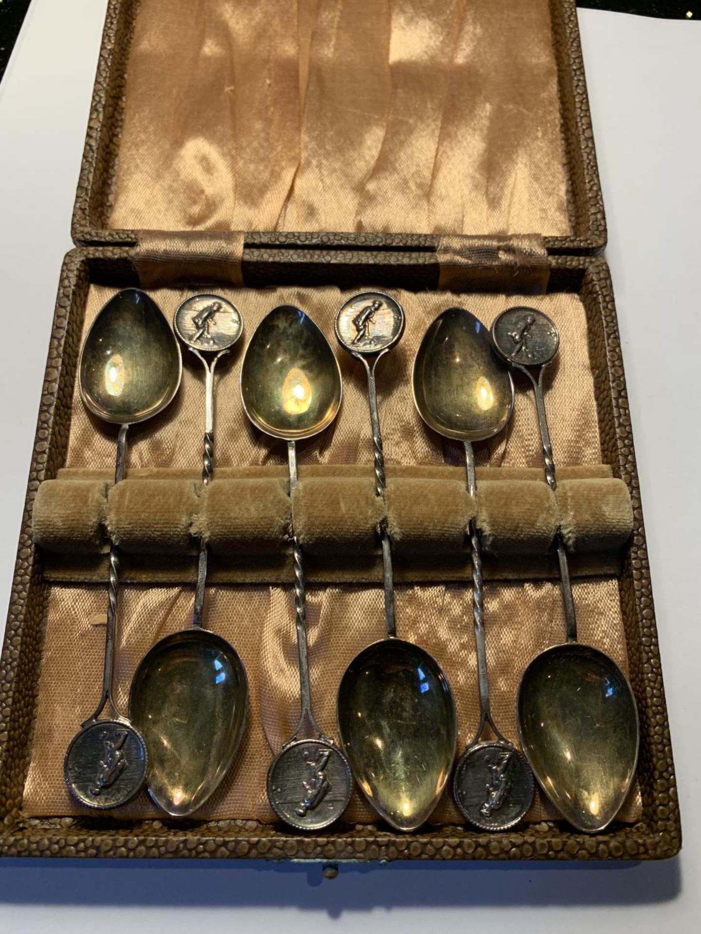 A SET OF SIX HALLMARKED SILVER BOWLING THEMED SPOONS IN A PRESENTATION BOX