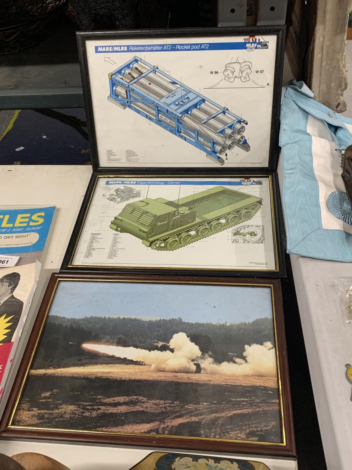 TWO FRAMED MILITARY PRINTS TO INCLUDE A ROCKET POD AT2 AND A CARRIER PLUS A PRINT OF A ROCKET