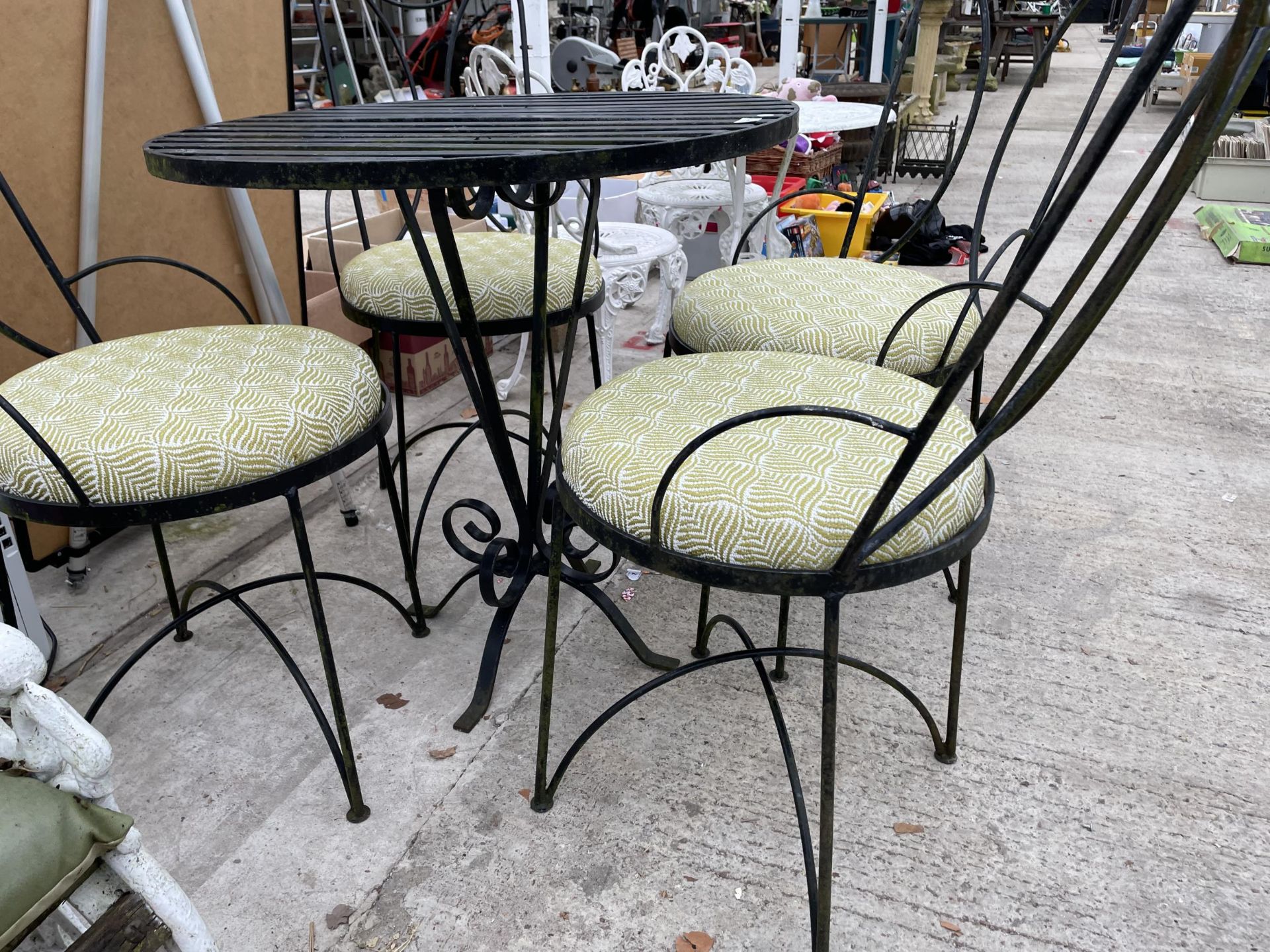 A DECORATIVE METAL PATIO BISTRO SET COMPRISING OF A ROUND TABLE AND FOUR CHAIRS WITH CUSHION SEATS - Image 3 of 3