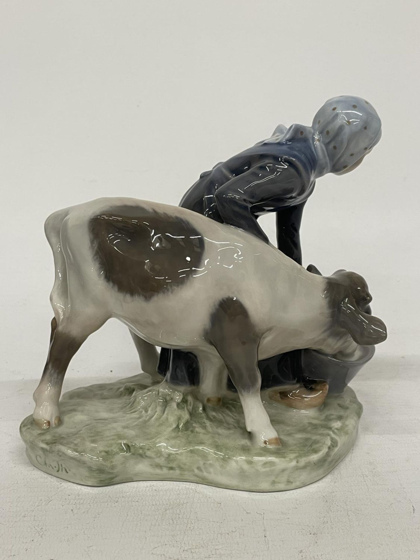 A ROYAL COPENHAGEN FIGURE OF A FARMGIRL AND CALF - DECORATION NUMBER 779 - DESIGNED BY CHRISTIAN - Image 3 of 5