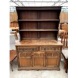 A REPRODUCTION OAK DRESSER COMPLETE WITH RACK, THE BASE ENCLOSING TWO DRAWERS AND TWO CUPBOARDS, 49"