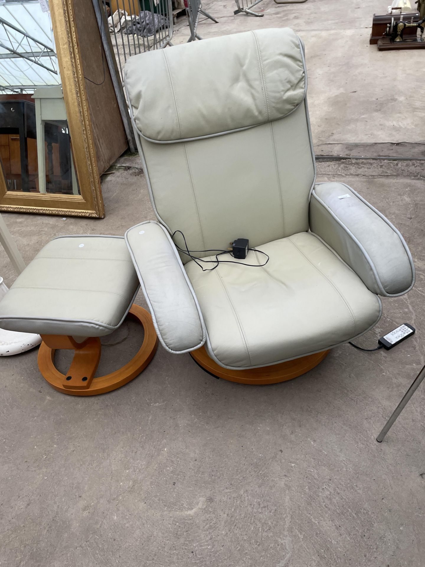 A SCOTTS & CO REVOLVING ELECTRIC RECLINER CHAIR AND STOOL