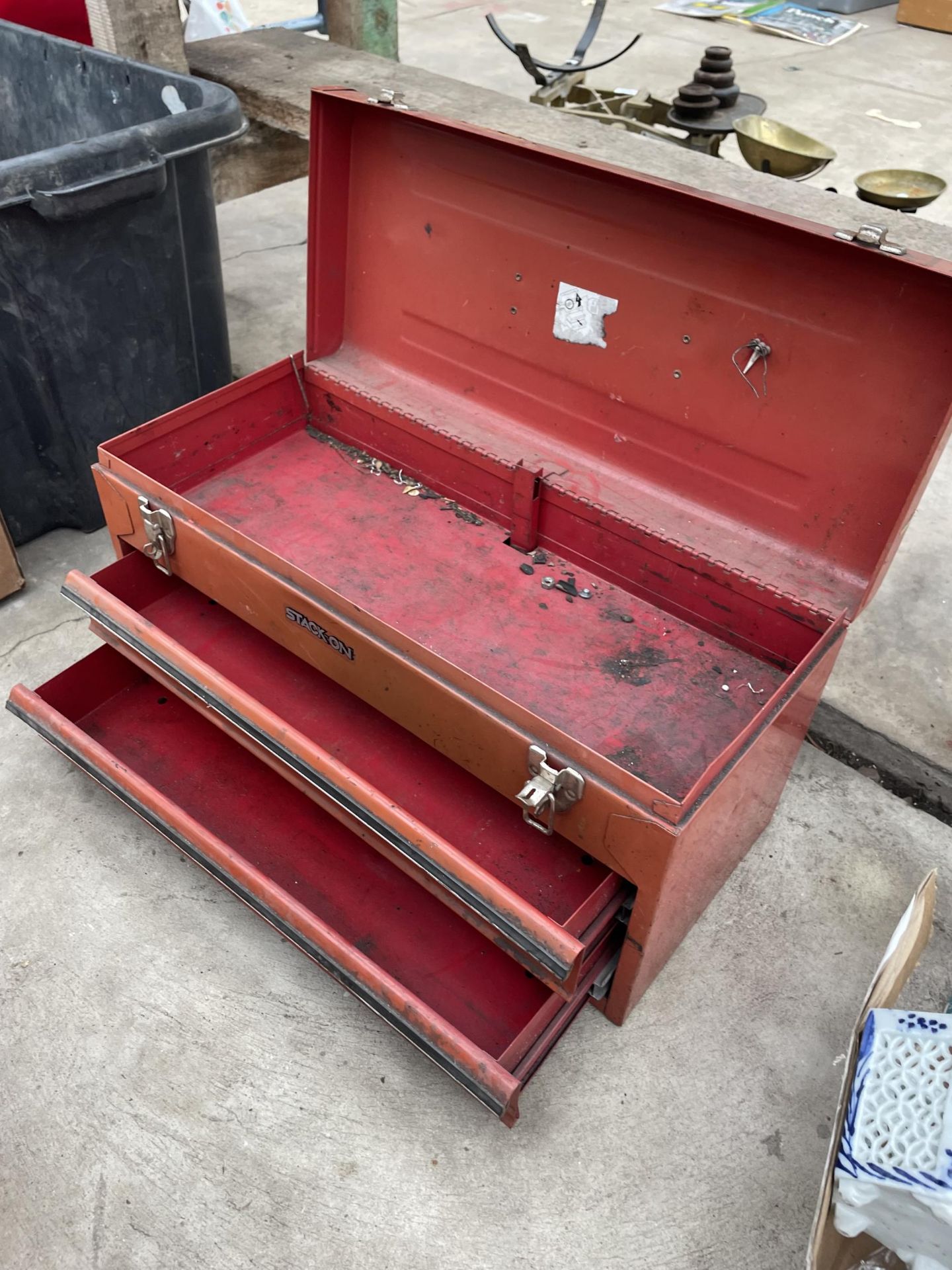 A RED METAL STACK ON TOOL BOX