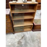 AN OAK MINTY FOUR TIER BOOKCASE WITH EIGHT SLIDING GLASS DOORS 35" WIDE