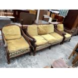 A 19TH CENTURY STYLE BERGERE THREE PIECE SUITE WITH CARVED SWEPT ARMS ON CABRIOLE LEGS WITH BALL AND