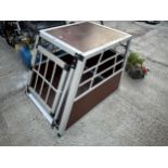 A SMALL WOODEN AND METAL CAR DOG CRATE