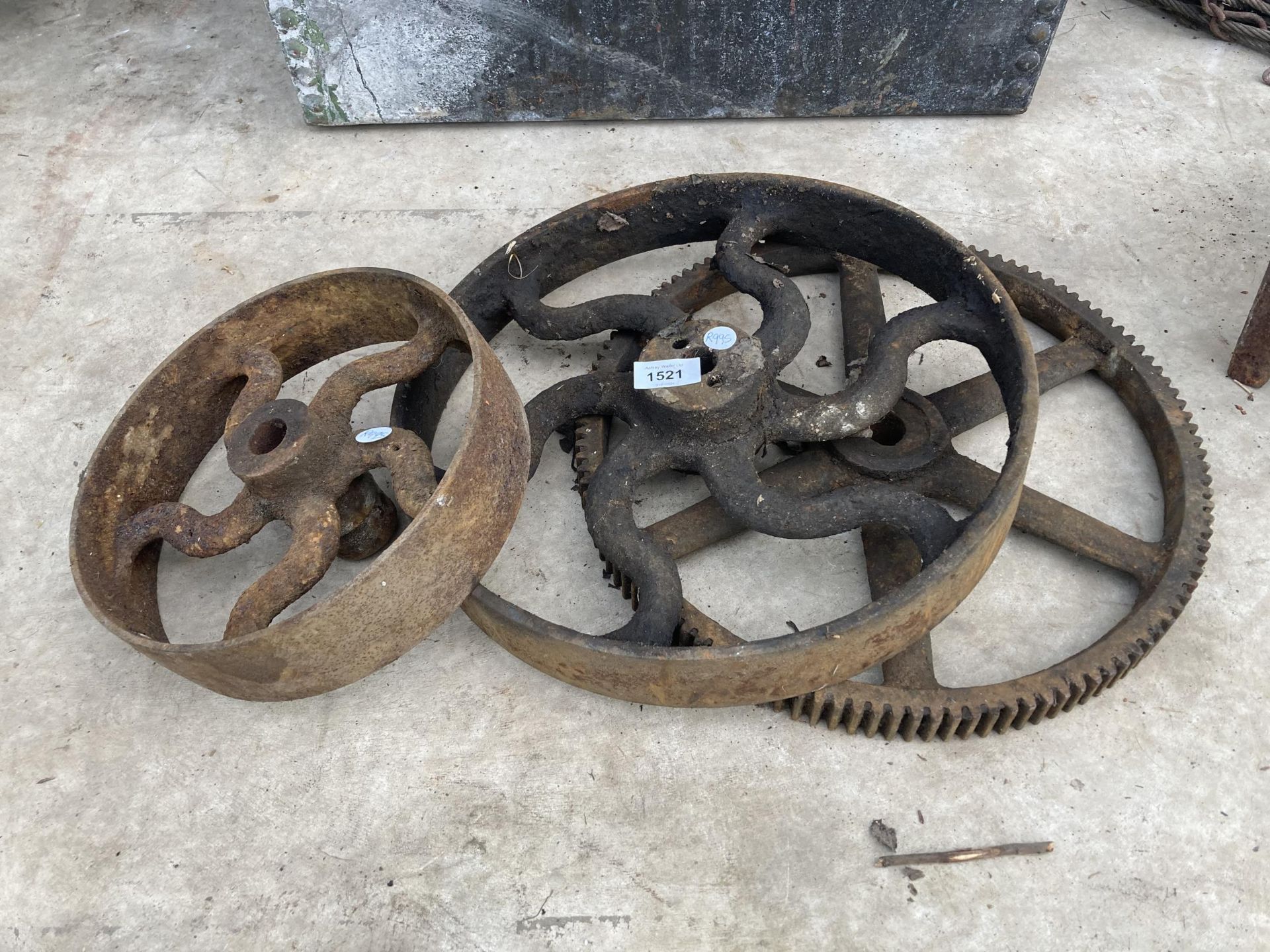 THREE VINTAGE CAST IRON WHEEL COGS