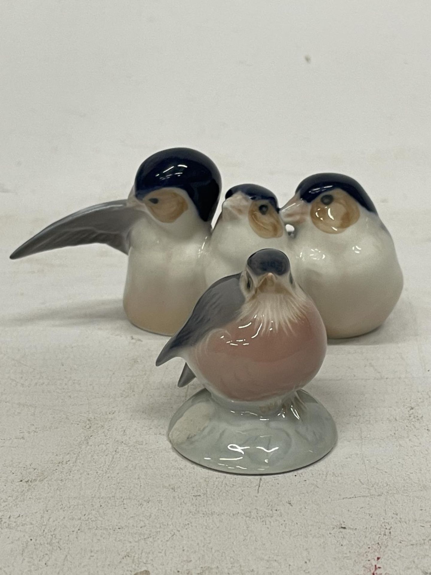 A ROYAL COPENHAGEN THREE FINCHES BIRD FIGURINE NUMBER 1045 TOGETHER WITH A BABY ROBIN - NO. 2238