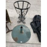 A LARGE METAL PARASOL STAND AND A METAL PLANT STAND