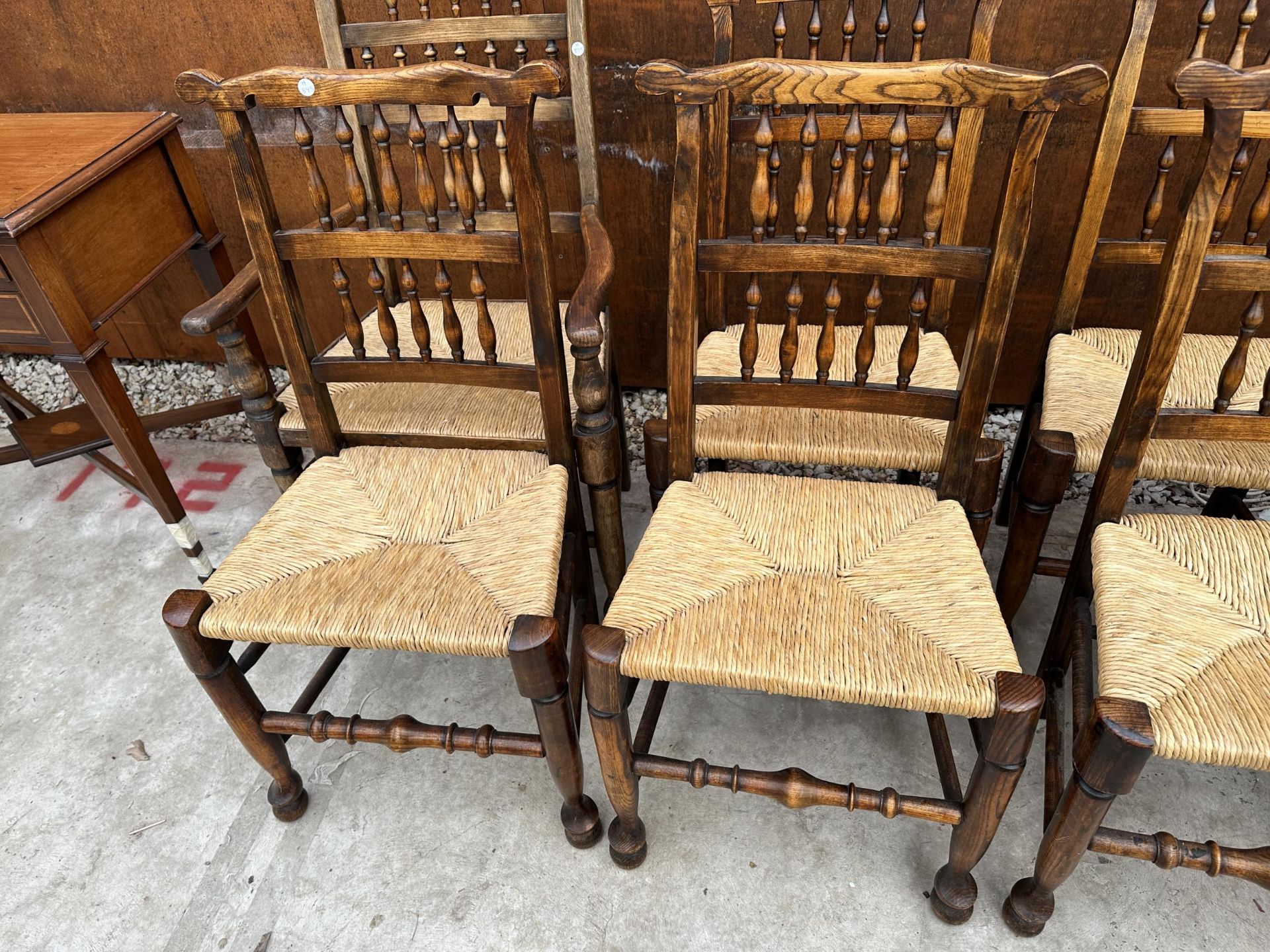 A SET OF EIGHT ELM AND BEECH LANCASHIRE SPINDLE BACK DINING CHAIRS, TWO BEING CARVERS, WITH RUSH - Image 3 of 5