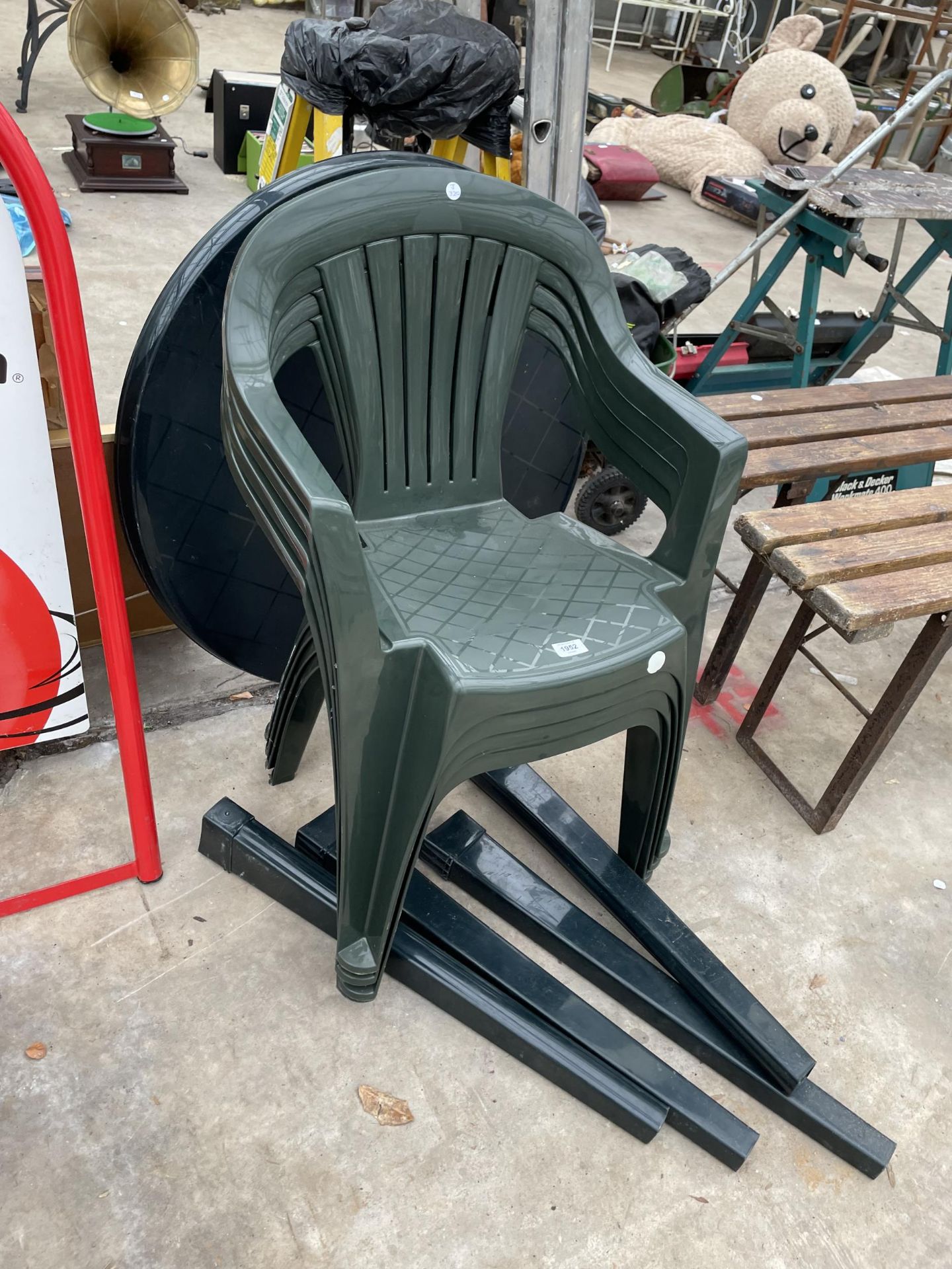 FOUR PLASTIC STACKING GARDEN CHAIRS AND A TABLE