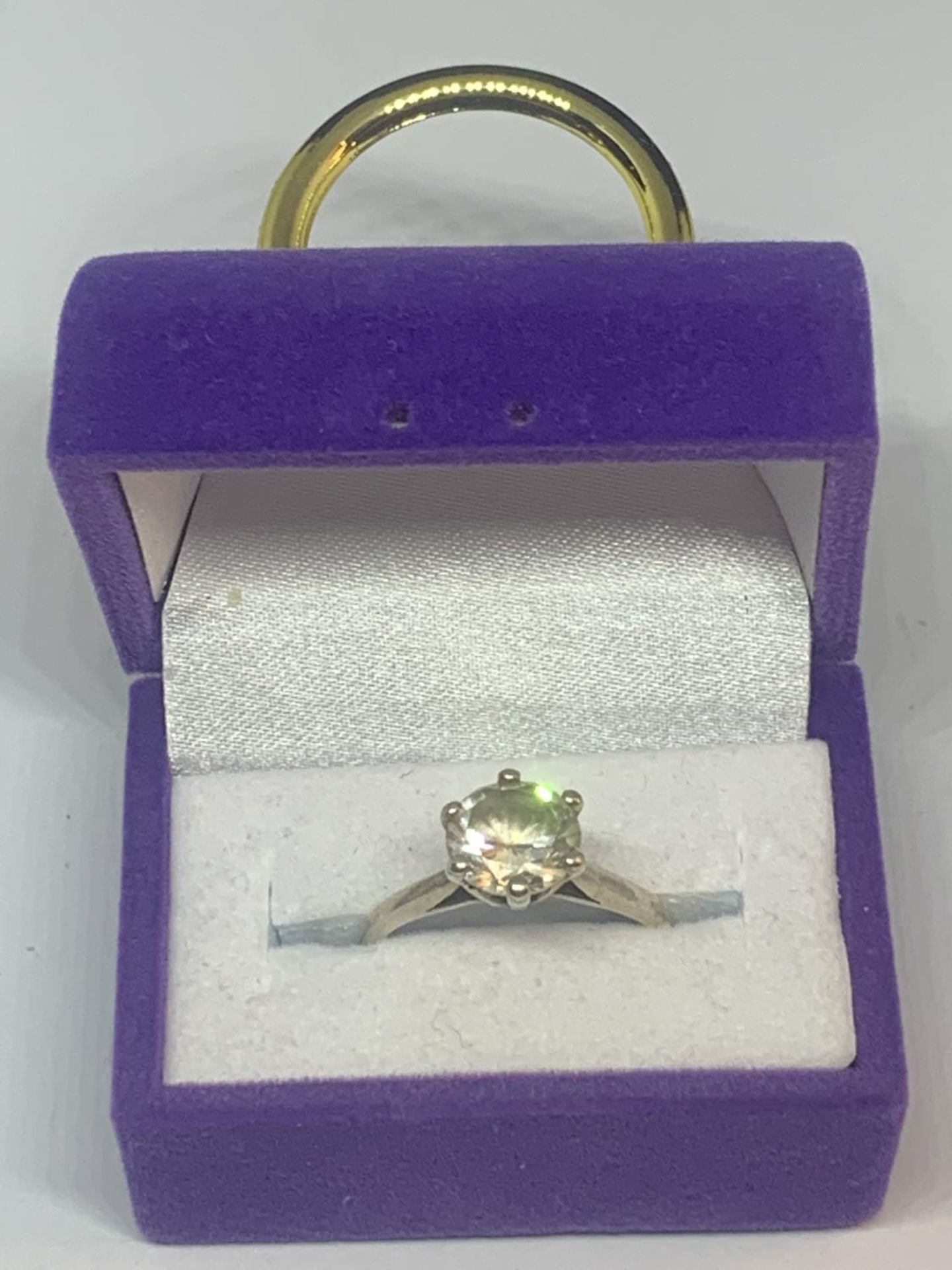 A SILVER RING WITH SOLITAIRE CLEAR STONE IN A PRESENTATION BOX