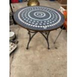 A ROUND METAL AND TILED TOP BISTRO TABLE