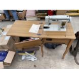 A WOODEN SEWING TABLE WITH A JANOME SEWING MACHINE