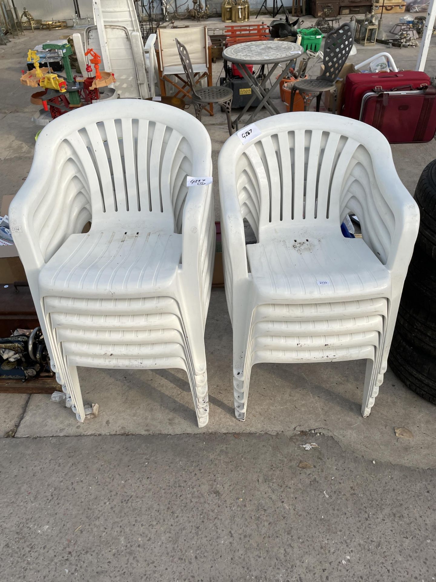 ELEVEN WHITE PLASTIC STACKING GARDEN CHAIRS