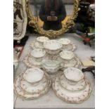 A VINTAGE CHINA PART TEASET WITH FLUTED EDGES AND A FLORAL PATTERN TO INCLUDE A SUGAR BOWL, CREAM