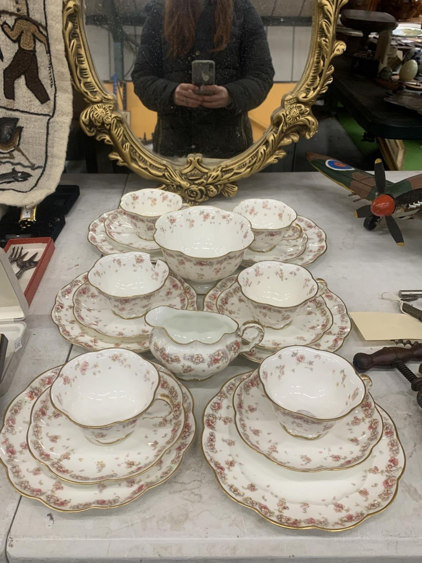 A VINTAGE CHINA PART TEASET WITH FLUTED EDGES AND A FLORAL PATTERN TO INCLUDE A SUGAR BOWL, CREAM