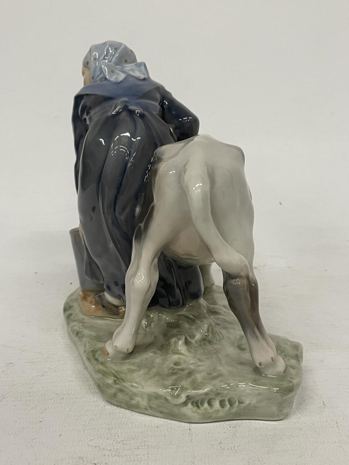 A ROYAL COPENHAGEN FIGURE OF A FARMGIRL AND CALF - DECORATION NUMBER 779 - DESIGNED BY CHRISTIAN - Image 4 of 5