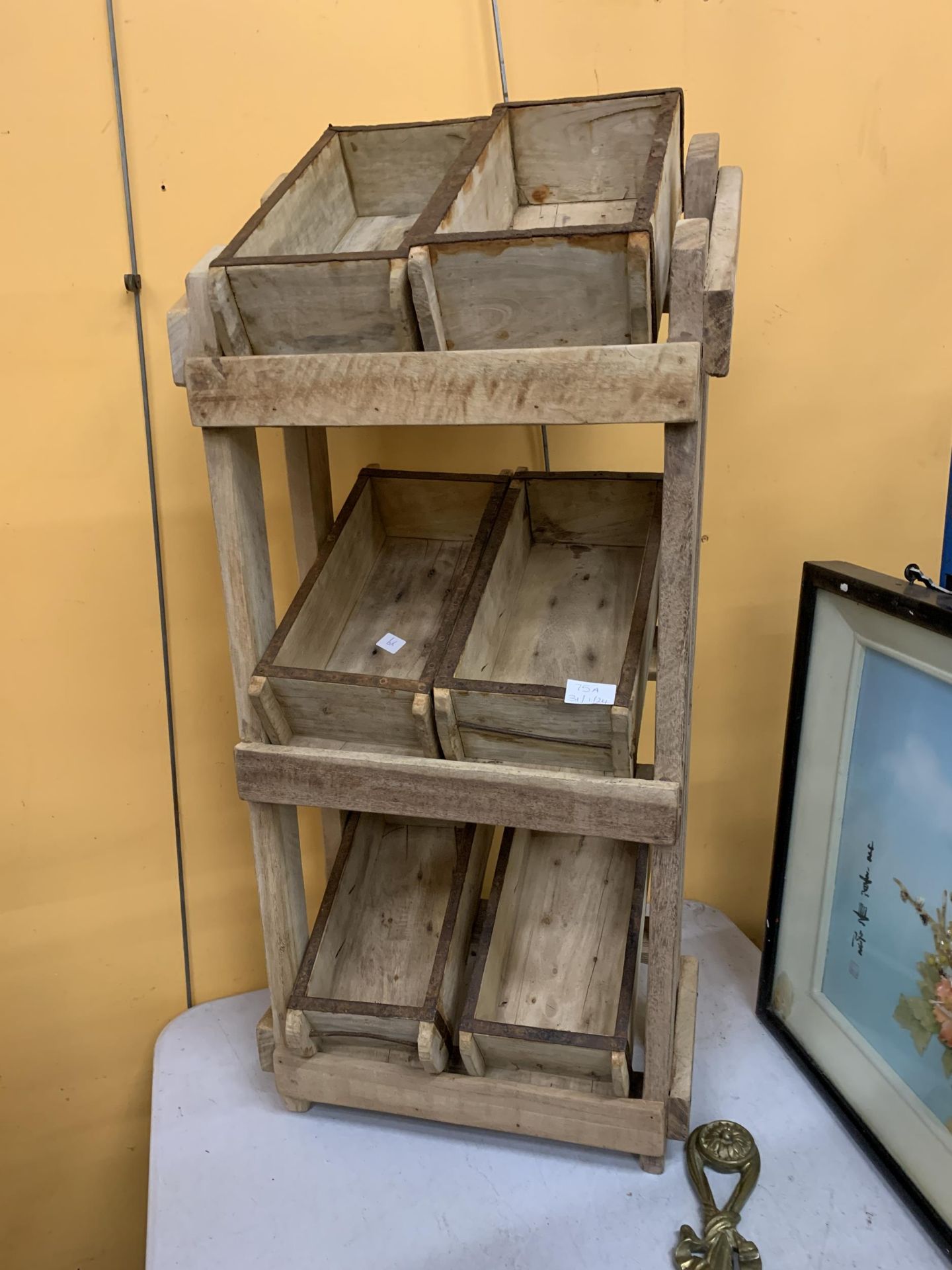 A WOODEN STORAGE RACK WITH SIX BRICK MOULD BOXES