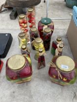 AN ASSORTMENT OF DECORATIVE STORAGE JARS CONTAINING ARTIFICIAL FRUIT