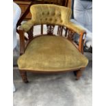 A LATE VICTORIN LOW TUB CHAIR WITH BUTTON BACK AND CARVED FRETWORK SUPPORTS