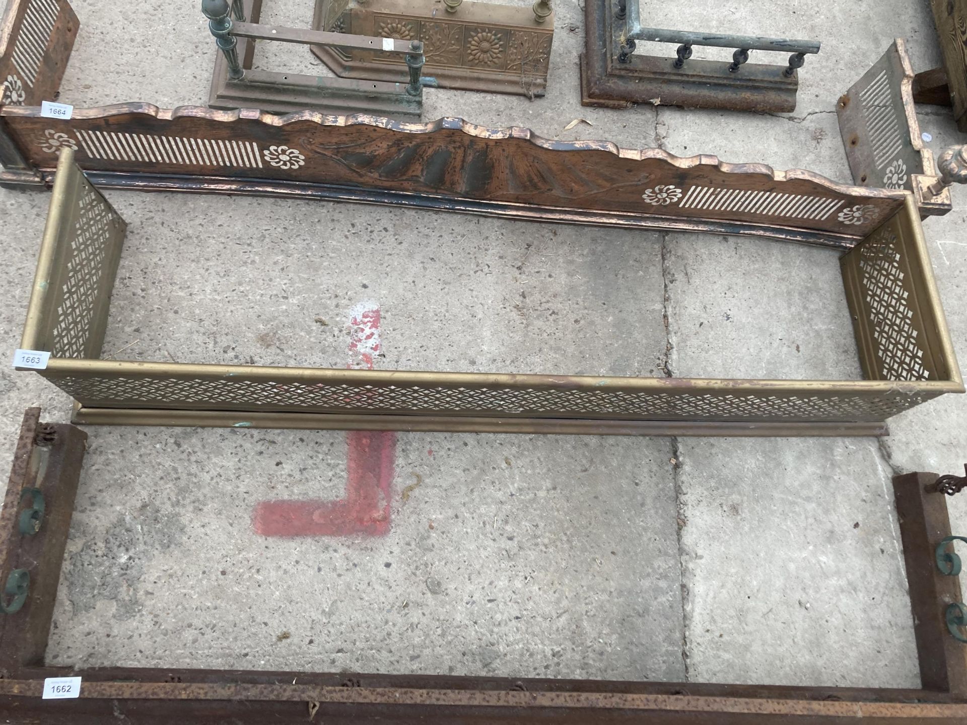 A VINTAGE BRASS FIRE FENDER WITH PIERCED PANELS