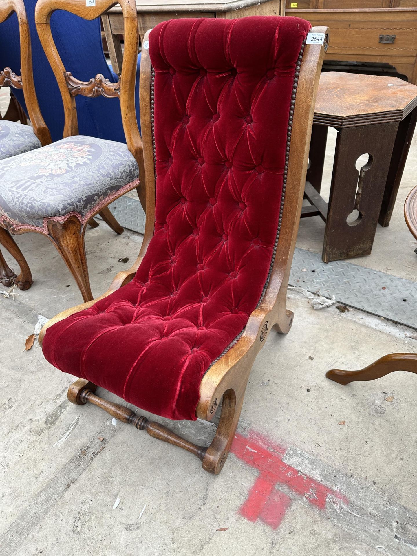 A VICTORIAN STYLE MAROON BUTTONED SLIPPER CHAIR