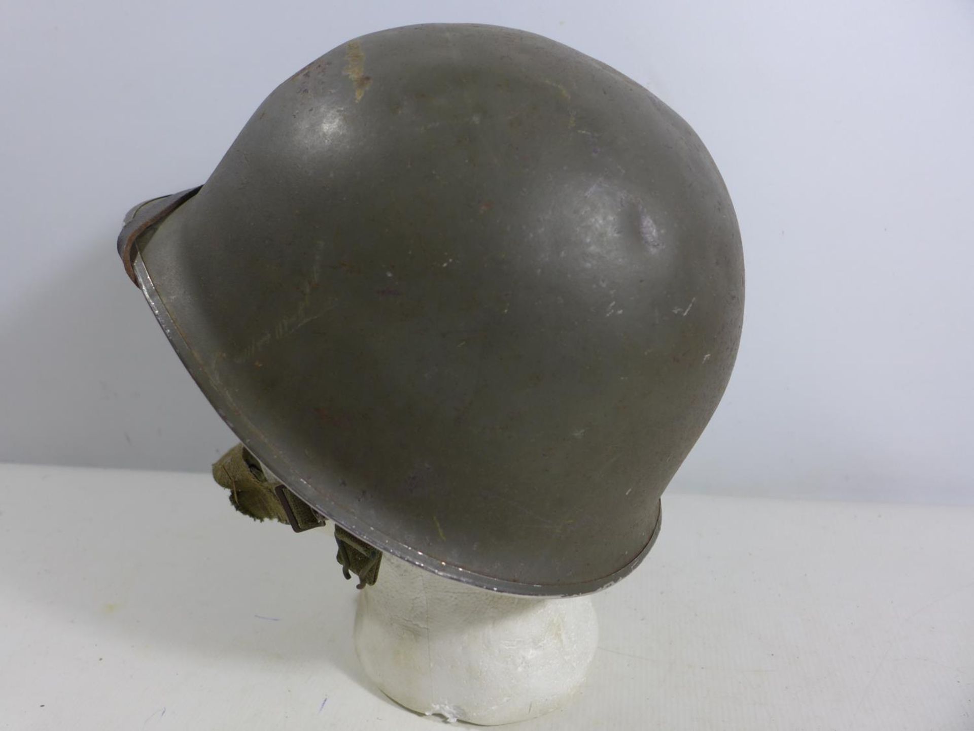 A GREEN PAINTED METAL MILITARY HELMET AND LINING - Image 2 of 6