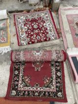 TWO SMALL RED PATTERNED RUGS