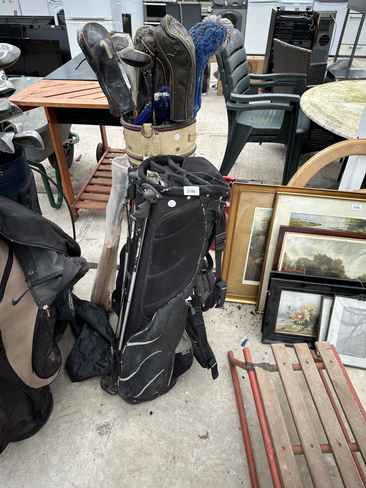 TWO GOLF BAGS AND AN ASSORTMENT OF VINTAGE GOLF CLUBS