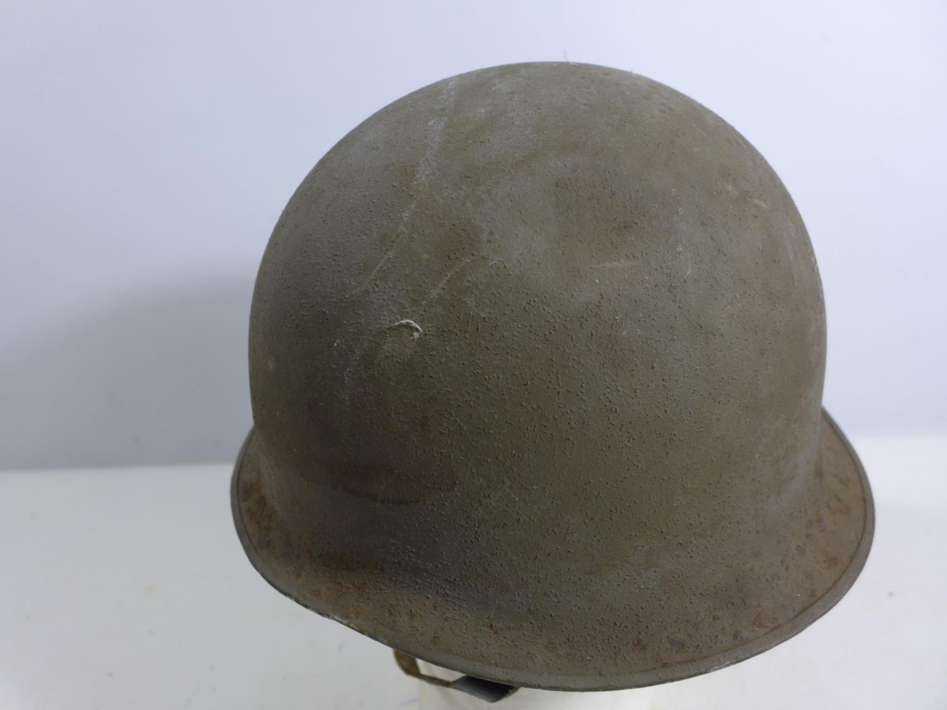 A GREEN PAINTED METAL MILITARY HELMET AND LINING - Image 2 of 3