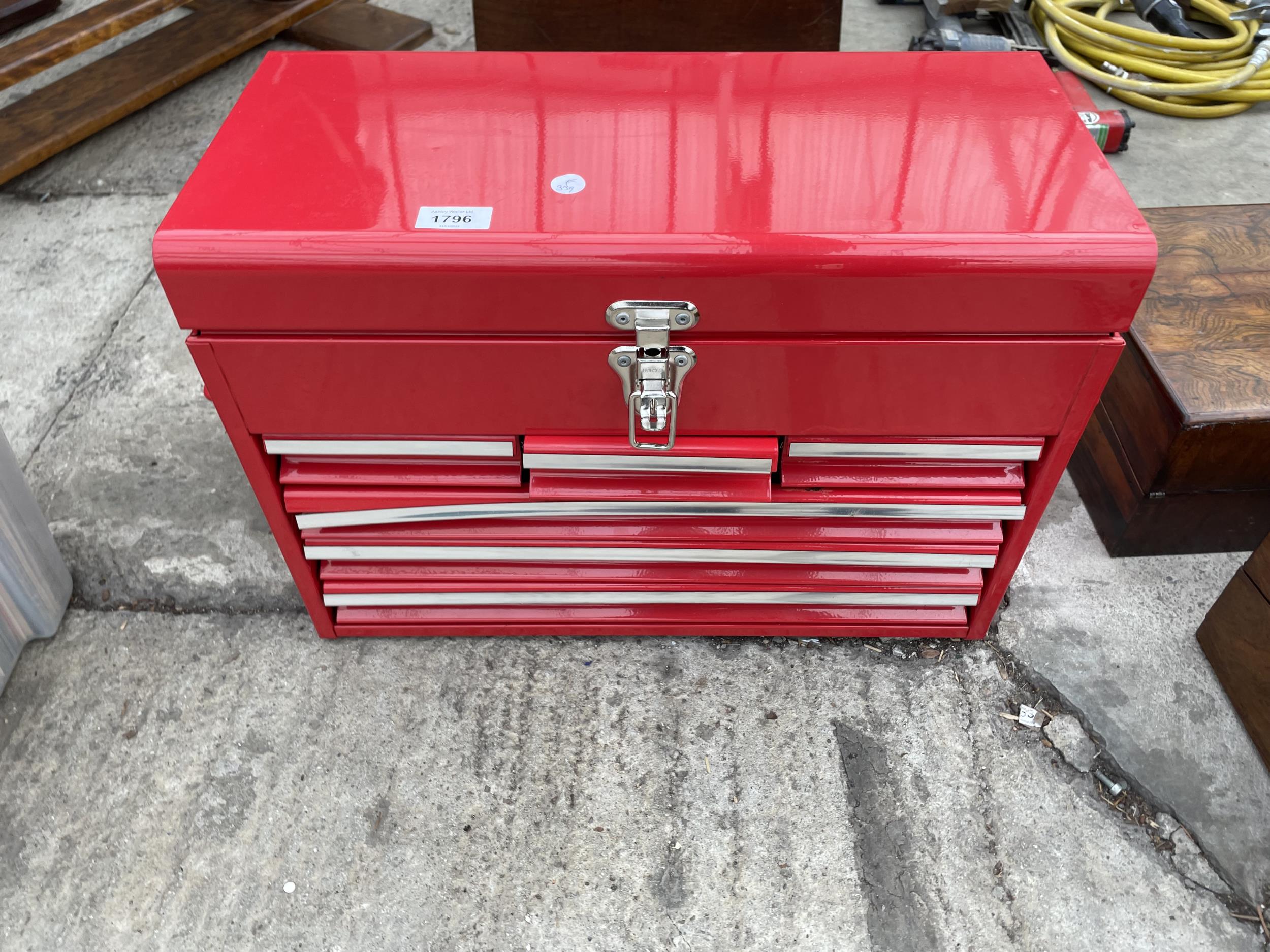A RED METAL WORKSHOP TOOL BOX WITH SIX DRAWERS AND A TOP STORAGE COMPARTMENT
