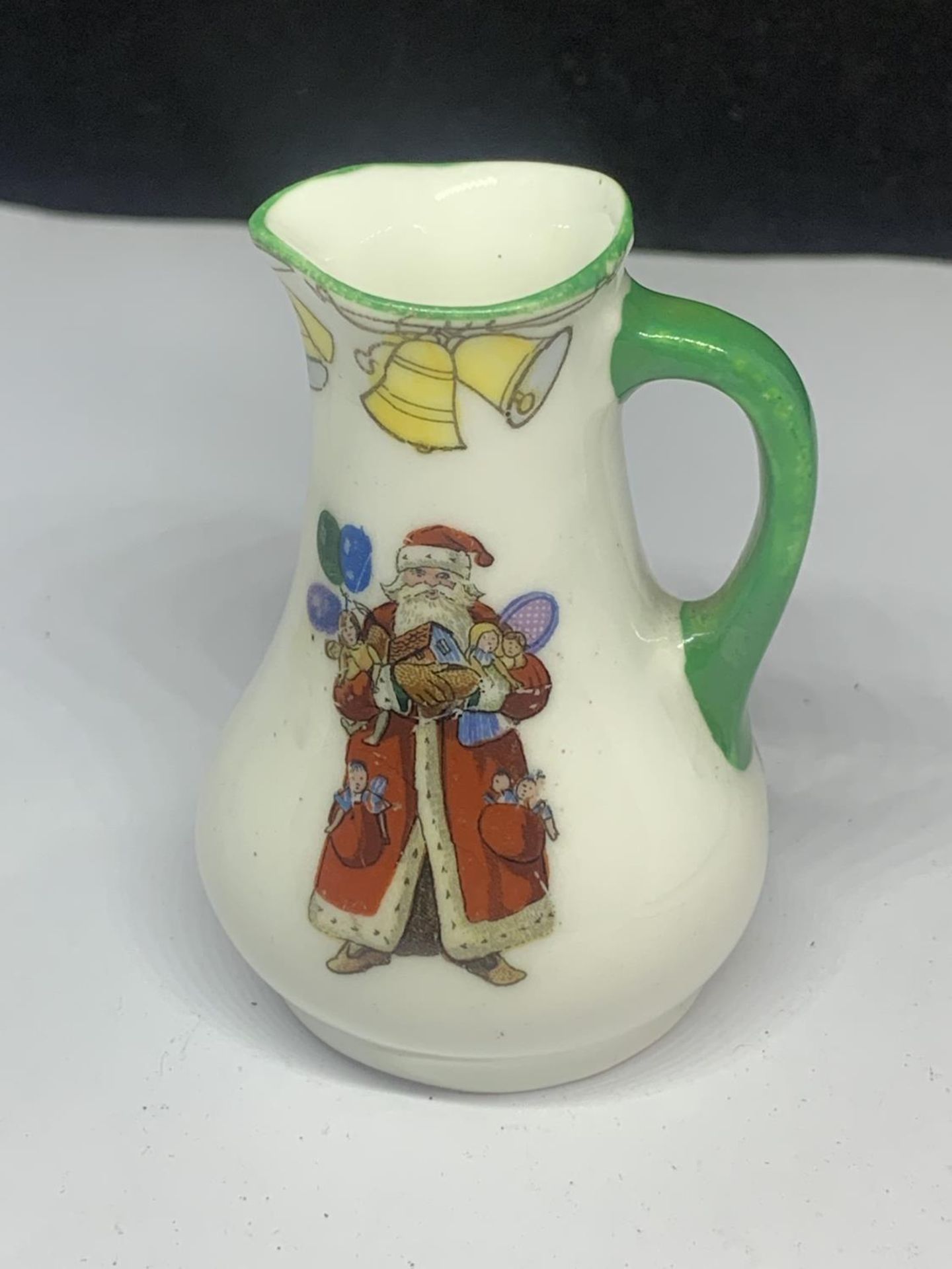 A MINIATURE ROYAL DOULTON JUG