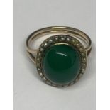 A YELLOW METAL RING WITH GREEN STONE AND PEARLS GROSS WEIGHT 5 GRAMS SIZE M/N