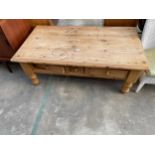 A PINE COFFEE TABLE WITH THREE DRAWERS - 49" X 28"