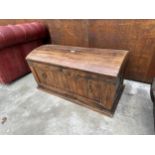 A DOMED HARDWOOD TRUNK WITH METAL BANDING AND RING HANDLES TO THE SIDES AND ENDS - 36" WIDE