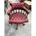 AN OXBLOOD BUTTONED LEATHER SWIVEL CAPTAIN'S CHAIR