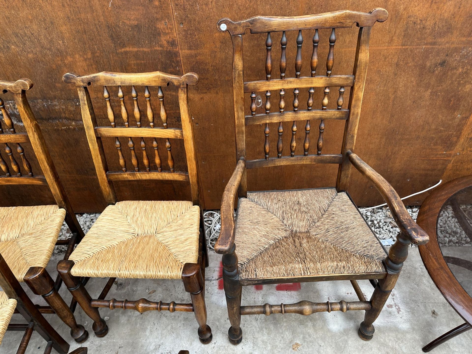 A SET OF EIGHT ELM AND BEECH LANCASHIRE SPINDLE BACK DINING CHAIRS, TWO BEING CARVERS, WITH RUSH - Image 4 of 5